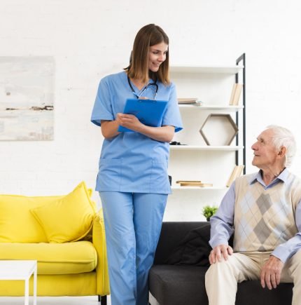 nurse-talking-old-man-sitting-black-sofa